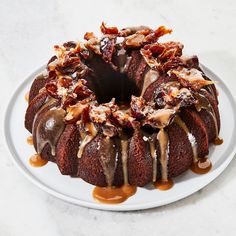 a chocolate bundt cake with caramel drizzle and nuts