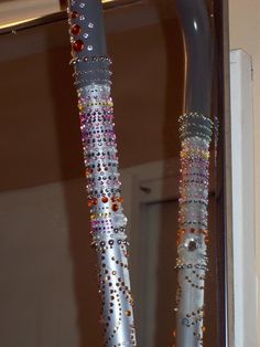 there are two silver and multicolored toothbrushes on display