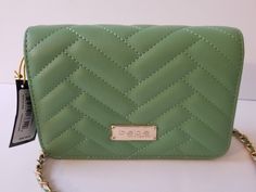 This elegant new with tag Bebe Sophia crossbody handbag is perfect for any occasion. The rectangular shape and quilted accents add a touch of sophistication, while the green exterior color and gold hardware provide a pop of style. The magnetic closure keeps your belongings secure,  giving it a sleek look. With a size of 7.5" by 4" by 2", this small bag is perfect for travel, weddings, parties, and even everyday use. The faux leather fabrication ensures durability for every day use. The bebe Sophia handbag is a must-have for any fashion-forward woman, making it a great addition to your collection. ***Please review pictures.*** Thank you for shopping with us! Green Quilted Crossbody Shoulder Bag, Chic Green Quilted Bag, Chic Quilted Green Bags, Trendy Green Quilted Shoulder Bag, Green Exterior, Handbag Straps, Small Crossbody, Wow Products, Small Bag