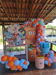 an outdoor birthday party with balloons and decorations