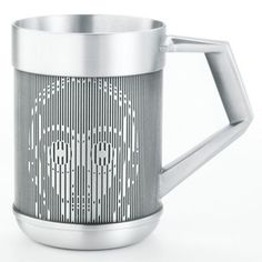 a stainless steel coffee mug with an intricate design on the front and sides, set against a white background