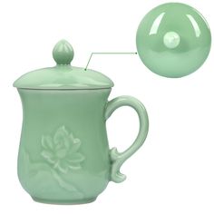 a green ceramic tea pot with a ball on the top and an image of a flower