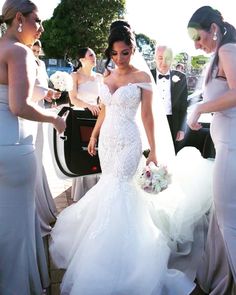 the bride is getting out of her car and ready to walk down the aisle with her friends