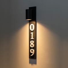 a black and white wall light with the number eighty nine on it's side