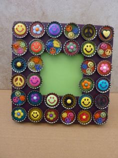 a frame made out of cupcakes with smiley faces and buttons in the middle