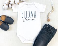 This personalized baby boy name onesie® is a perfect way to announce your baby's name and for them to wear when they are here! Also available in toddler sizes. Please note the photo props are just for picture purposes and are not included with your purchase. 💖Want a matching pink one for a gender reveal? Check that out here - https://www.etsy.com/listing/1658723934 💙HOW TO ORDER -Choose your size and style from the drop down menus (available sizes and styles are listed in the photos) -In the personalization box, write the name you need. If you would like to see how the fonts would look with the name you need, please message me and I'd be happy to send that to you. -Add listing to your cart -Double check your address and make sure it is correct when going through checkout ✨IMPORTANT ONESI Baby Name Onesie, Fitted Onesie With Letter Print For Gender Reveal, Custom Onesies Boy, Personalized White Onesie For Father's Day, Personalized Fitted Cute Onesie, Personalized Onesie Boy, Baby Boy Onsies Cricut Monogram, Monogram Onesies, Boys Monogrammed Onesie