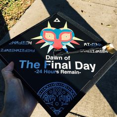 a person holding up a graduation cap with the words dawn of the final day on it