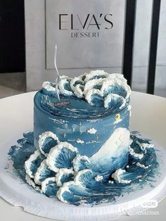 a blue and white cake sitting on top of a table