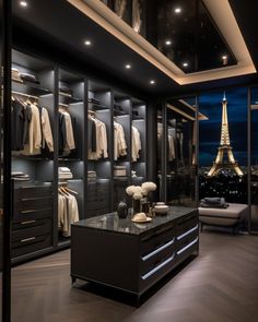 a walk - in closet with clothes on hangers and an eiffel tower in the background