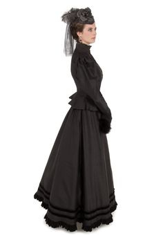 The traditional late-Victorian silhouette is accomplished beautifully with a closely-fitted bodice featuring a high neckline with a stand-up collar made of shirred black silk chiffon and trimmed in lace, with many small buttons closing the front. A gently ruffled peplum skims over the hips. Large poufed sleeves taper to lace-trimmed narrow cuffs, which have an additional black silk chiffon deep ruffle at the wrist. The hem of the matching skirt is finished with a black velvet ruffle, just below Black Victorian Dress, Victorian Ball Gowns, Black Wedding Dress Gothic, Weird West, Victorian Gown, Gothic Wedding Dress, Bustle Dress, Cocktail Dress Vintage, Victorian Clothing