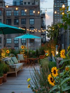 an outdoor seating area with sunflowers and lights strung over the top of buildings