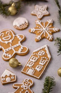 gingerbread cookies decorated with white icing and gold decorations