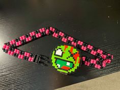 a pac - man beaded lanyard and keychain on top of a table