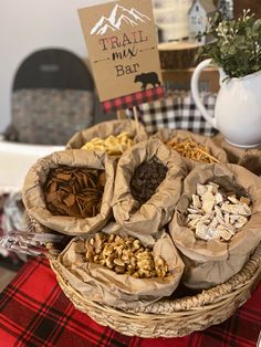 there are many different types of nuts in the basket on the table with a sign that says trail mix bar