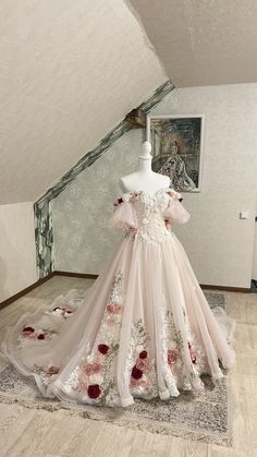 a dress on display in an attic with flowers all over the skirt and off the shoulder