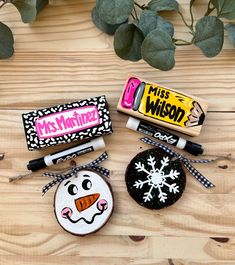 three decorated cookies on top of a wooden table