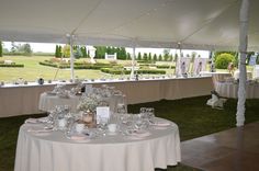 tables set up for an event with white linens