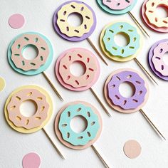 colorful donuts are on top of candy lollipops in the shape of doughnuts