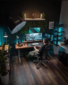 a man sitting at a desk in front of a computer