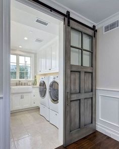 an open door leading to a washer and dryer in a white laundry room