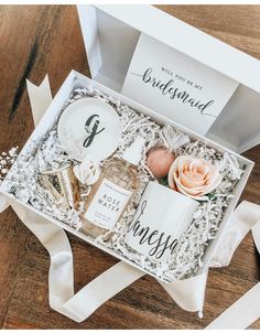 the bridesmaid gift box is filled with personalized items for her wedding day