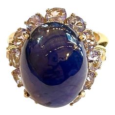 This is part of Chairish’s Fine Jewelry assortment.  Blue Sapphire Cabochon - 12 Carat Lilac Tanzanite   - 3 Carats  This Ring is from the "Orient" traveling collection are the epitome of elegance and versatility. It offers a perfect blend of day to night and swimwear to evening wear, allowing you to effortlessly transition between different occasions and outfits. Wearing these spectacular oriental-style ring will undoubtedly make you the center of attention. It addw a touch of glamour and sophi Formal Oval Cabochon Sapphire Ring, Luxury Multi-stone Cabochons For Formal Occasions, Luxury Sapphire Cabochon Ring, Luxury Formal Cabochon Amethyst Ring, Luxury Formal Amethyst Cabochon Ring, Luxury Sapphire Cabochon Ring For Anniversary, Elegant Sapphire Cabochon Rings, Luxury Amethyst Cabochon Ring For Formal Occasions, Luxury Multi-stone Oval Cabochons