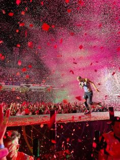 a person on a stage surrounded by confetti