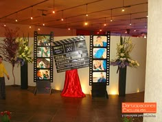 a man standing in front of a movie screen on top of a hard wood floor