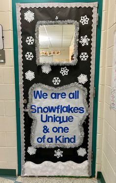 a door decorated with snowflakes and saying we are all snowflakes unique & one of a kind