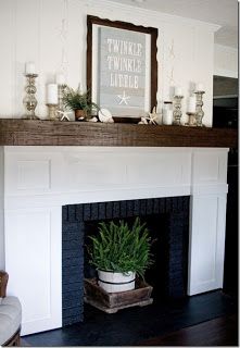 a living room with a fire place and a potted plant on the mantel