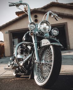 a black and silver motorcycle parked in front of a house