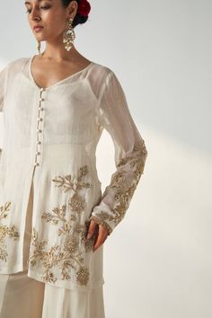 Ivory kurta with hand embroidery on the sleeves and kurta hem. Paired with a sharara and bustier. - Aza Fashions Elegant Off White Embroidered Sets, Designer Cream Sharara With Intricate Embroidery, Elegant Off White Sets With Intricate Embroidery, Elegant Off-white Sets With Intricate Embroidery, Off White Anarkali Palazzo Set With Intricate Embroidery, Elegant Cream Sharara With Resham Embroidery, Festive Off White Palazzo Set With Intricate Embroidery, Elegant Embroidered Off White Anarkali Set, Festive Off-white Palazzo Set With Intricate Embroidery