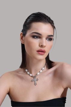 💎 Elevate your look with our Zircon and Pearl Cross Necklace, a stunning piece that combines sparkling zircon stones with the timeless beauty of pearls. This show-stopping pendant is perfect for those who love bold, elegant jewelry that makes a statement. Whether you're dressing up for a special event or adding a touch of glamour to your daily look, this cross necklace is sure to shine! ✨ At LuxoticaBoutique, we bring together cool, modern designs with classic sophistication. Each piece is craf Elegant Silver Cross Pearl Necklace, Elegant Cross-shaped Pearl Pendant Necklace, Elegant Cross Necklace With Pearl Pendant, Elegant Cross Pendant Necklace With Pearl Drop, Elegant Pearl Drop Cross Pendant Necklace, White Crystal Jewelry With Pearl Charm, White Pearl Necklace With Metal Pendant, White Pearl Pendant Jewelry, White Pearl Pendant Necklace In Metal