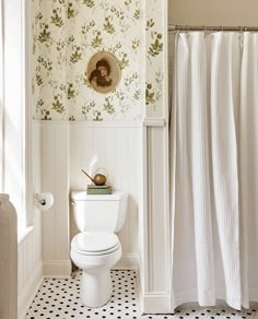 a white toilet sitting in a bathroom next to a shower