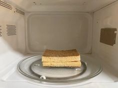 two pieces of cake sitting on top of a plate in a microwave oven with the door open