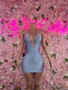 a mannequin wearing a blue dress in front of pink flowers with the words king and queen written on it