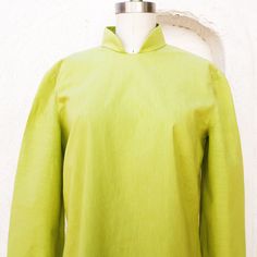 1960's lime green cotton shift dress with 3/4 sleeves, a back zipper, and a Nehru collar. It doesn't have front darts. There are 19 inch side slits. Simple, comfortable style. Fits like a medium. measurements with room for comfort: Bust up to: 37 inches Waist up to: 36 inches Hips up to: 38 inches. Exact measurements taken flat to compare to a garment which fits well: Length: 40 inches. Bust: 19 1/2 inches. Waist: 19 inches. Hips: 20 inches Sleeve length: 19 inches. Shoulders across the back: 16 Green Stand Collar Top For Spring, Green Cotton Top With Stand Collar, 1960s Mod Dress, Empire Waist Gown, Cotton Shift Dress, 1960s Mod, Hip Ups, Comfortable Style, Mod Dress