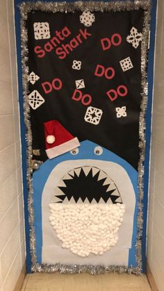 a door decorated to look like a shark with a santa hat on it's head