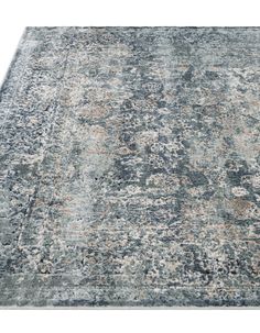 an area rug with various colors and patterns on the carpet, including blue, gray, beige