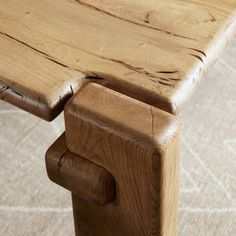 a close up of a wooden bench on the floor