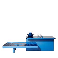 a blue table with a bowl on it and a drain in the middle next to it