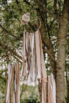 an image of a wedding decoration hanging from a tree