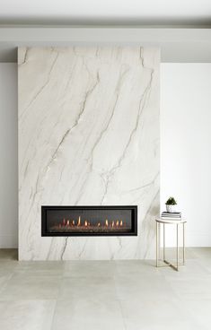 a white marble fireplace in a modern living room