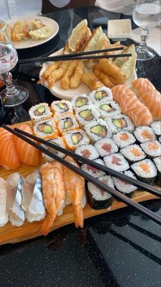 an assortment of sushi and other foods on a table