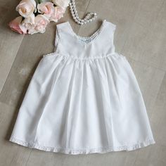 This Feltman Brothers White Under Slip Is A Classic For Any Baby Girl's Wardrobe. Perfect For Little Dresses That Are A Bit Sheer Or Wear By Itself As A Little White Sundress. Add A Small Monogram To The Front For A Special Touch. White Cotton Blend With A Sweet Delicate French Lace Trimming The Neckline And Arm Openings. Fits 9-12 Months (See Measurements) Brand New Without Tags. Difficult To Find Item!! 11 Inches Across Chest From Underarm Sea To Other Underarm Seam 15 Inches Long From Top Of