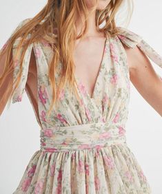 This gorgeous floral print mini dress features a v-neckline, a tiered body, a smocked waistband and self tie straps. Feminine and chic, this dress is perfect for day or night. 100% polyester Lined Self tie straps V-front and back Model is wearing a size small and is 5'10" FINAL SALE - CANNOT BE RETURNED OR EXCHANGED Spring V-neck Mini Dress With Tie Straps, Summer Floral Ruched V-neck Dress, Ruched V-neck Floral Dress For Summer, Summer V-neck Ruched Floral Dress, Summer V-neck Floral Dress With Smocked Back, Summer Floral V-neck Dress With Smocked Back, Spring Floral V-neck Dress With Smocked Back, V-neck Dress With Tie Straps For Garden Party, V-neck Mini Dress With Smocked Bodice For Garden Party