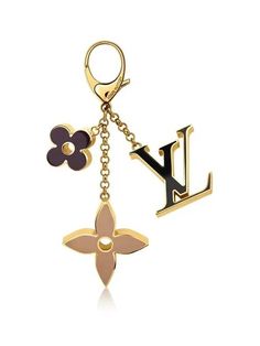 a keychain with the letter l on it and flowers hanging from it's side