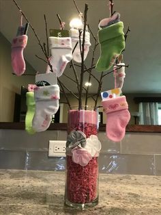 a vase filled with baby socks and candy