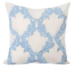 a blue and white pillow on a white background