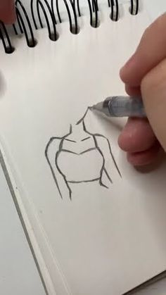 someone is drawing a woman's torso on paper